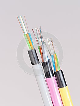 Different colored fiber optic cable ends with stripped jacket layers and exposed colored fibers
