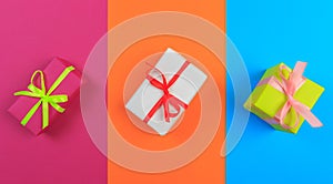 Different colored gift box on color background. Top view of various present boxes on minimal background. Birthday, Christmas,