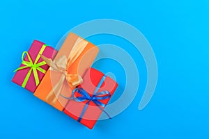 Different colored gift box on color background. Top view of various present boxes on minimal background. Birthday, Christmas,