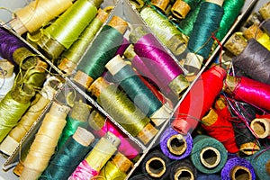 The different colored spools of thread