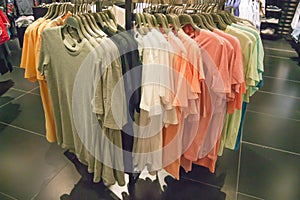 Different colored t-shirt in stock in a luxury store - man wear photo