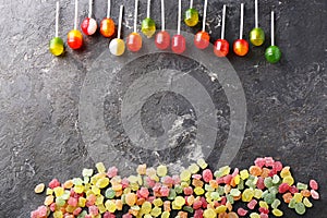 Different colorful candies on grey background