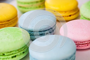 Different colorful macaroons background. Selective focus