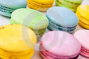 Different colorful macaroons background. Selective focus