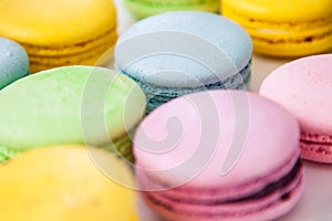 Different colorful macaroons background. Selective focus