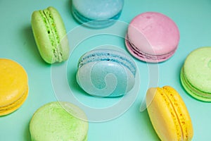 Different colorful macaroons on blue background