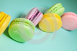 Different colorful macaroons on blue background