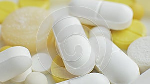 Different colorful medication and pills on white lab table. Creative health care of pharmaceutical concept. Close up of