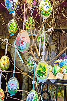 Different colorful painted Easter eggs on the tree at traditional European market