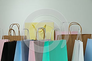 Different colorful paper bags on white background