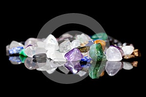 Different colorful rough gems, minerals and crystals in front of
