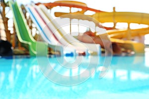 Different colorful slides in water park, blurred