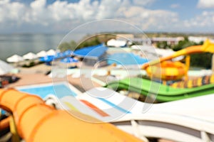 Different colorful slides in water park, blurred