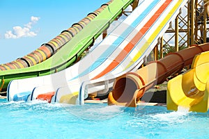 Different colorful slides in water park on day