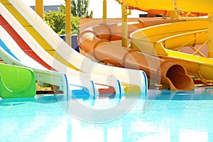 Different colorful slides in water park on day