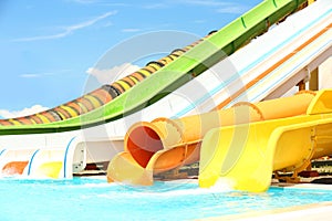 Different colorful slides in water park on day