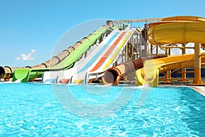 Different colorful slides in water park on day