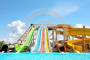 Different colorful slides in water park on day