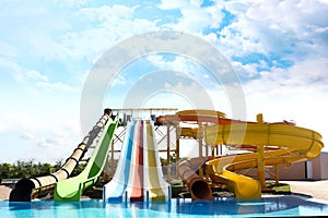 Different colorful slides in water park on day