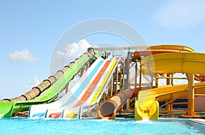 Different colorful slides in water park on day