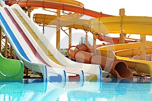 Different colorful slides in water park on day