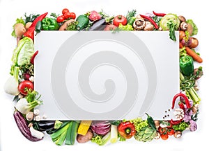 Different colorful vegetables arranged as a frame on white background.