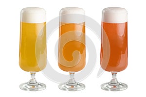 Different colors of foamy beer served in tulip pilsner glasses isolated on white background