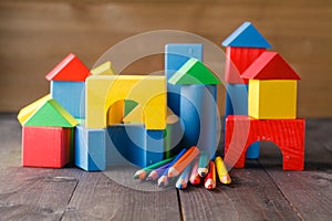 Different colors of pencils ontable with building blocks