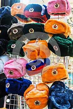 Different colors Russian ushanka hats with cockades