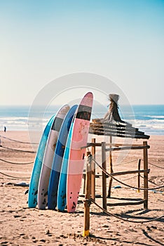 Different colors of surf on a the sandy beach in Casablanca - Morocco. Beautiful view on sandy beach and ocean. Surf boards for re