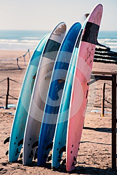 Different colors of surf on a the sandy beach in Casablanca - Morocco. Beautiful view on sandy beach and ocean. Surf boards for re