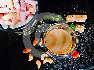 Different coloured marshmellows in glass