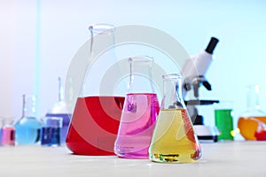 Different conical flasks with samples on table in laboratory