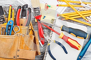 Different construction tools, wooden background