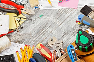 Different construction tools, wooden background