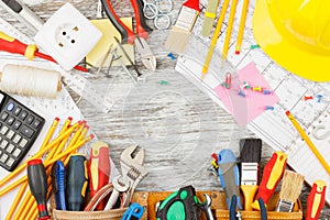 Different construction tools, wooden background
