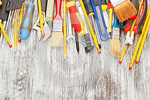 Different construction tools, wooden background