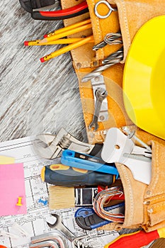 Different construction tools, wooden background