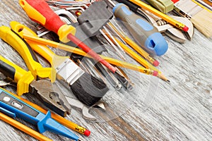 Different construction tools, wooden background