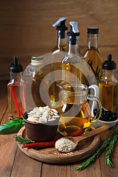 Different cooking oils and ingredients on wooden table