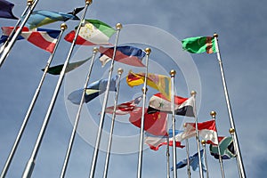 Different countries flags united together against blue sky