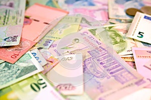 Different currency note and coins from different countries background