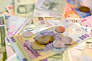 Different currency note and coins from different countries background