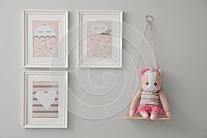 Different cute pictures on wall. Baby room interior