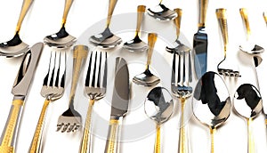 Different cutlery - forks, spoons and knives on a white background