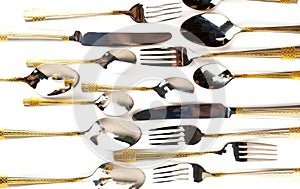 Different cutlery - forks, spoons and knives on a white background