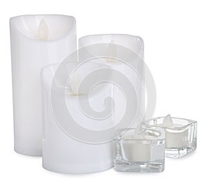 Different decorative flameless LED candles on white