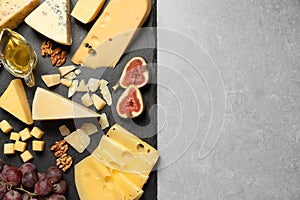 Different delicious cheeses served on  table, top view. Space for text