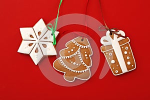 Different delicious Christmas cookies on red background, flat lay