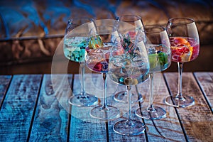 Different delicious cocktails on table in bar. alcoholic coctail with fruit, herbs and ice, Space for text